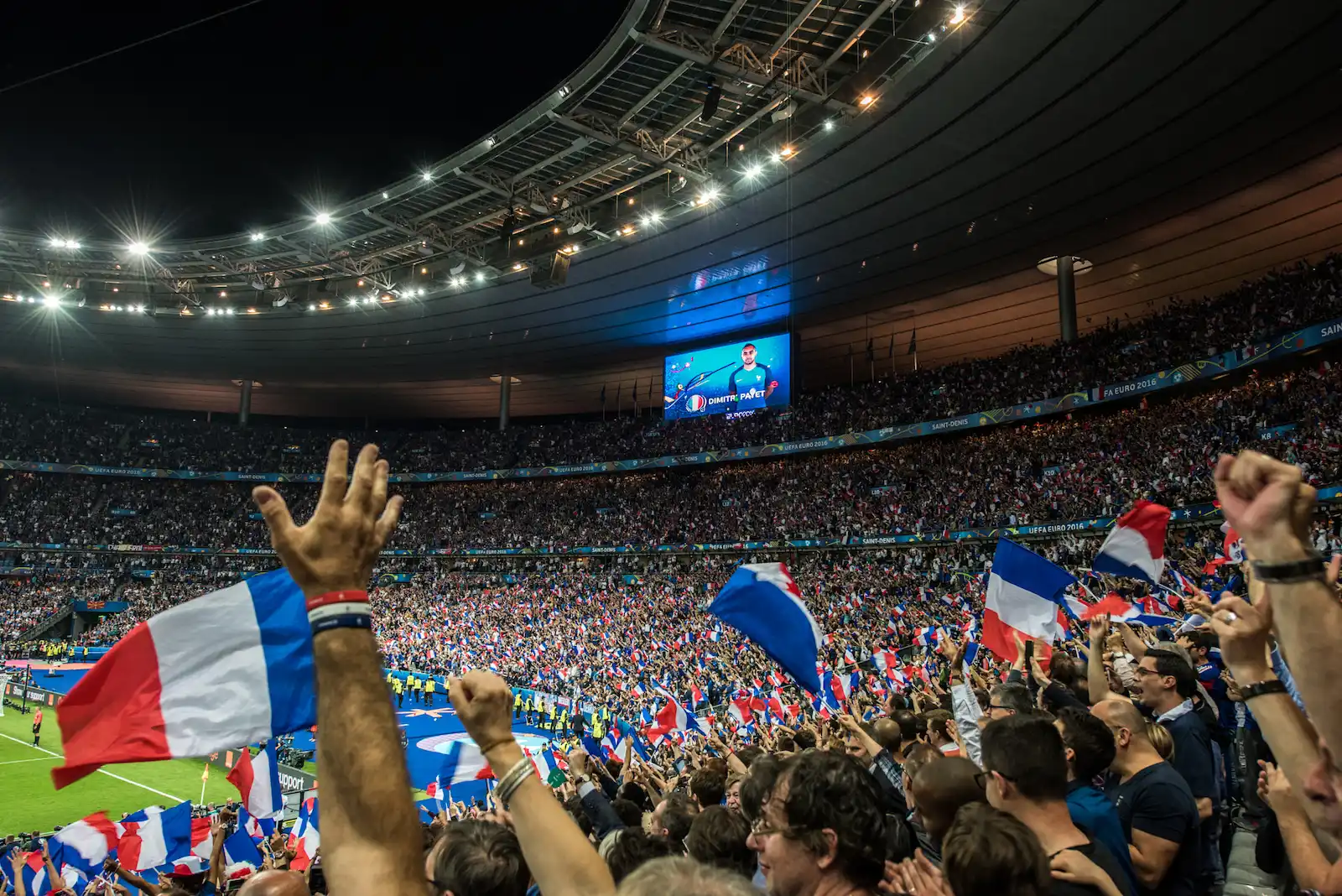 France soccer fans waving their tricolore flags in celebration